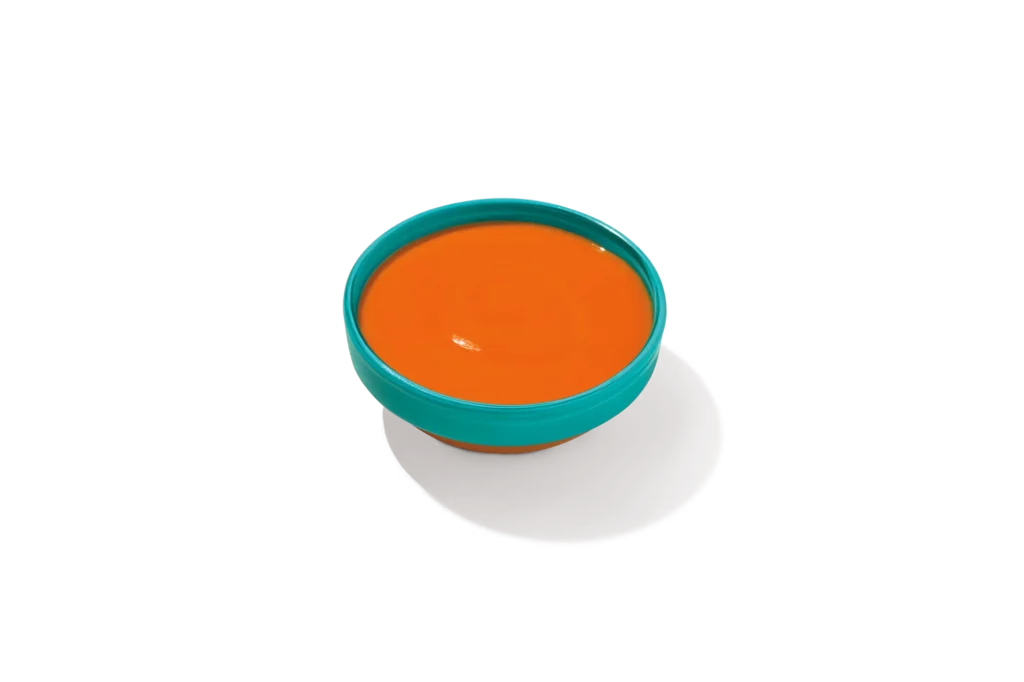 "Bowl of Bayou Buffalo Sauce on a white background."