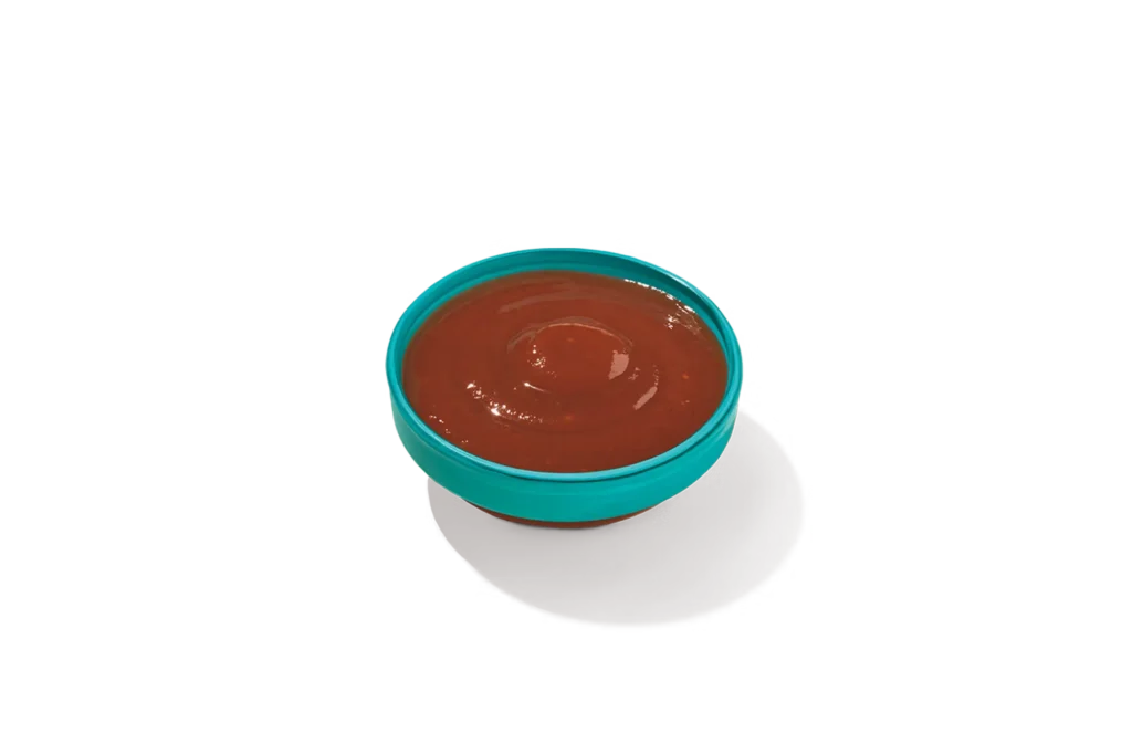 "Bowl of Bold BBQ Sauce on a white background."