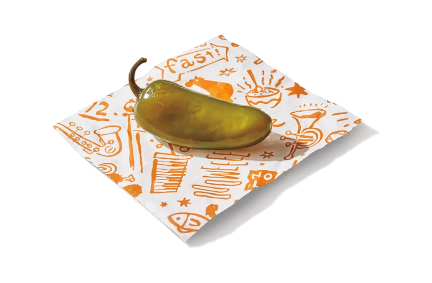 "Pickled jalapeño pepper on a paper napkin."