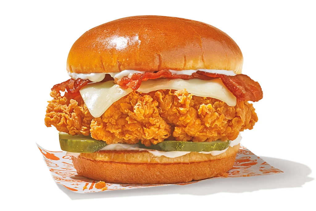 "Bacon & Cheese Chicken Sandwich with fried chicken, bacon, cheese, pickles, and mayonnaise."
