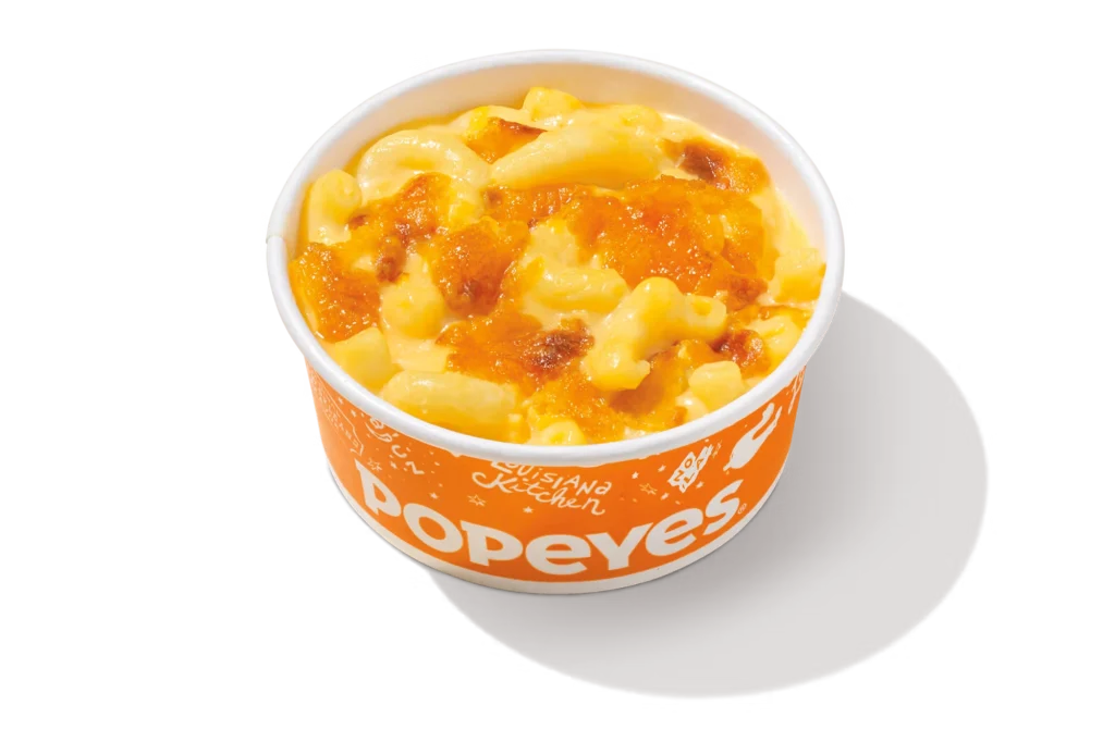 "Popeyes Homestyle Mac & Cheese in an orange container."