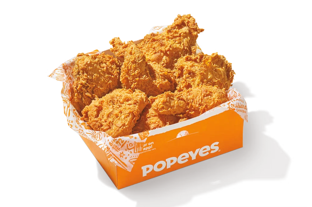 "8Pc Signature Chicken in Popeyes branded packaging, featuring crispy fried chicken pieces."