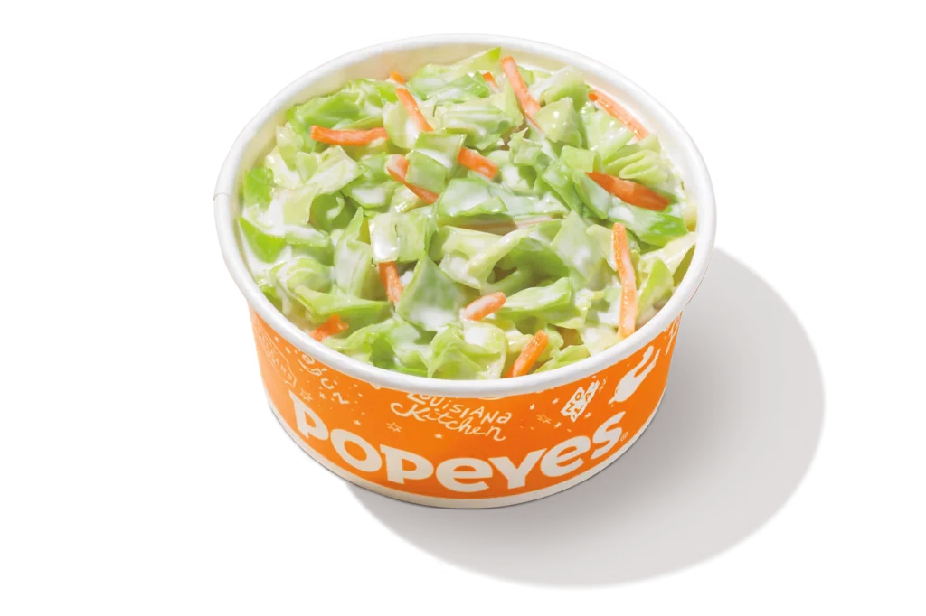 "Popeyes coleslaw in an orange container."