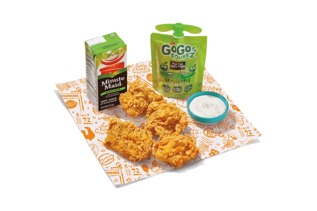 "4-piece boneless kids meal with juice box, apple sauce, ranch dip, and crispy chicken pieces."