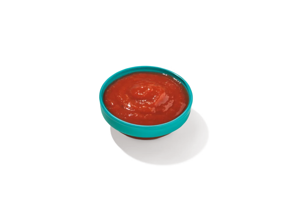 "Bowl of Cocktail Sauce on a white background."