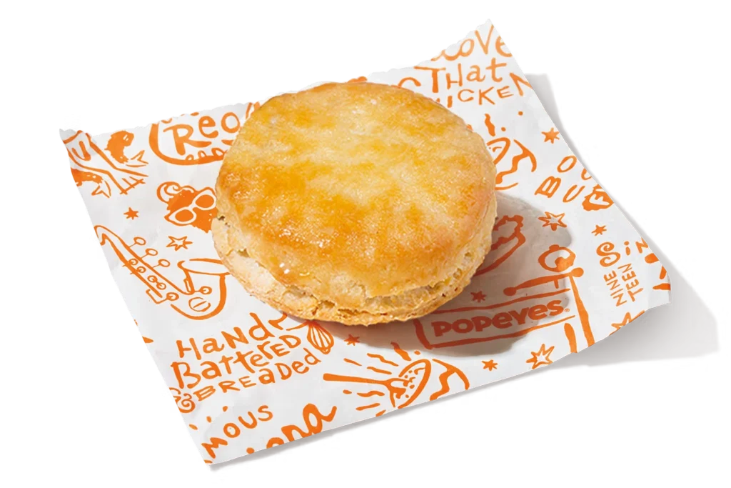 "Popeyes biscuit on a paper napkin."