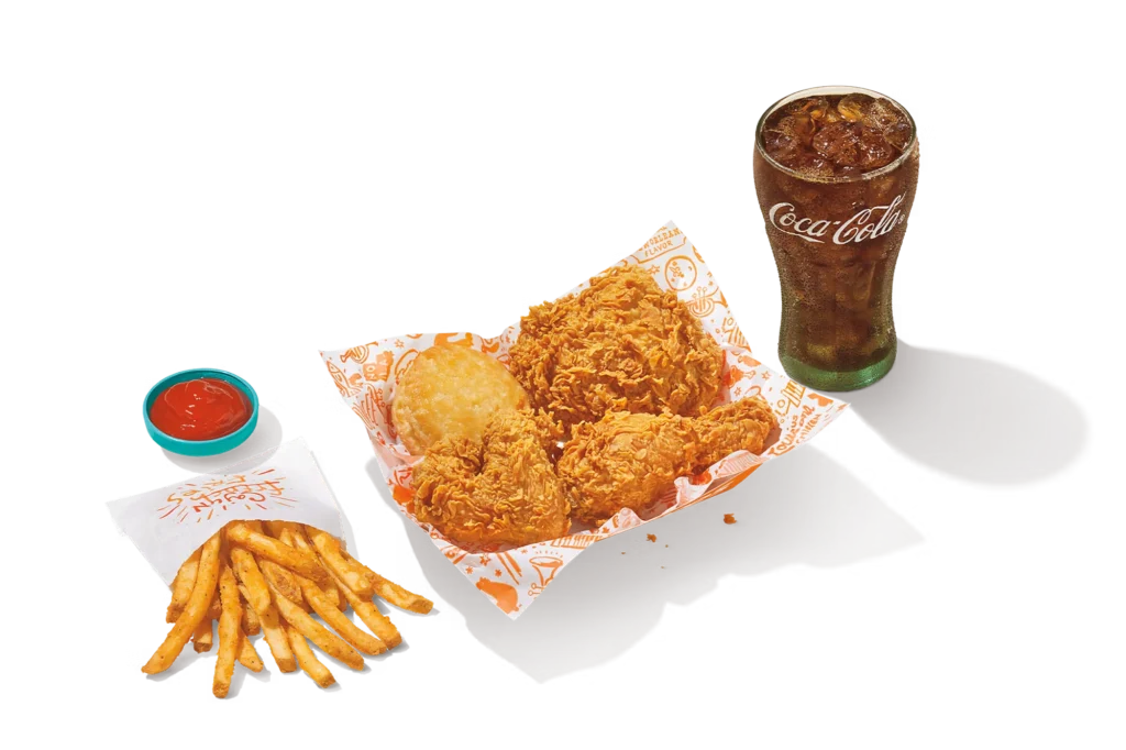 "3Pc Signature Chicken meal with crispy fried chicken, fries, biscuit, dipping sauce, and Coca-Cola."