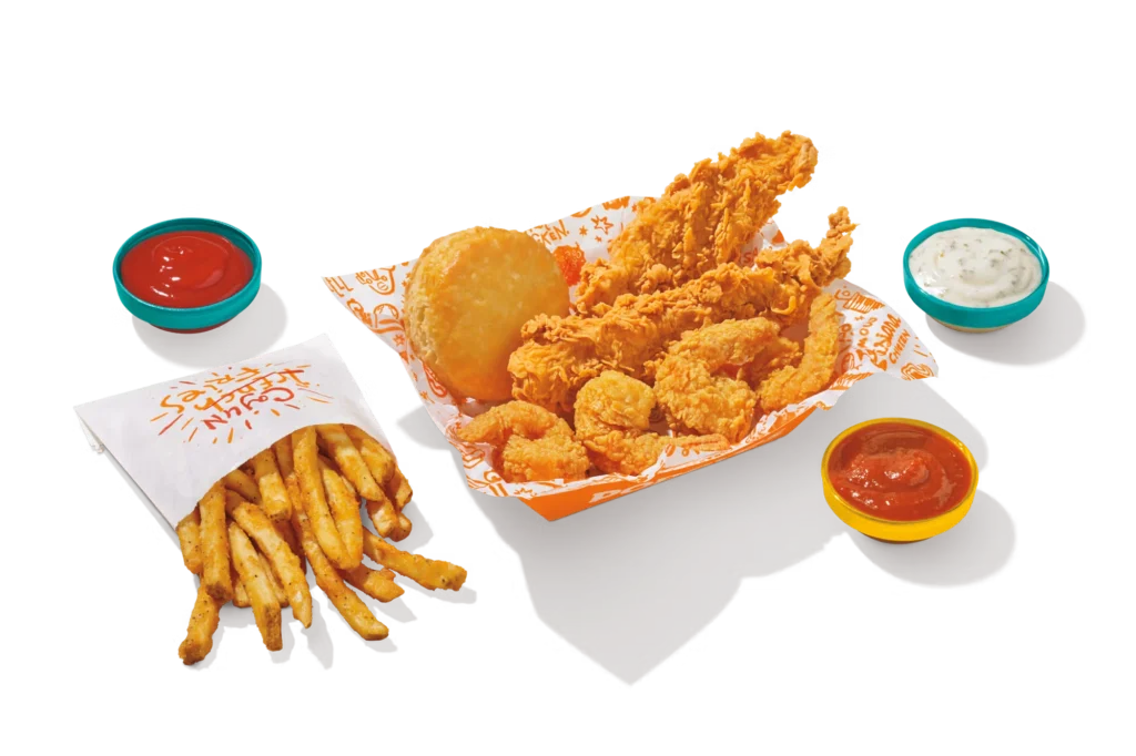 "Popeyes Surf & Turf meal with fries, shrimp, tenders, biscuits, and dipping sauces."