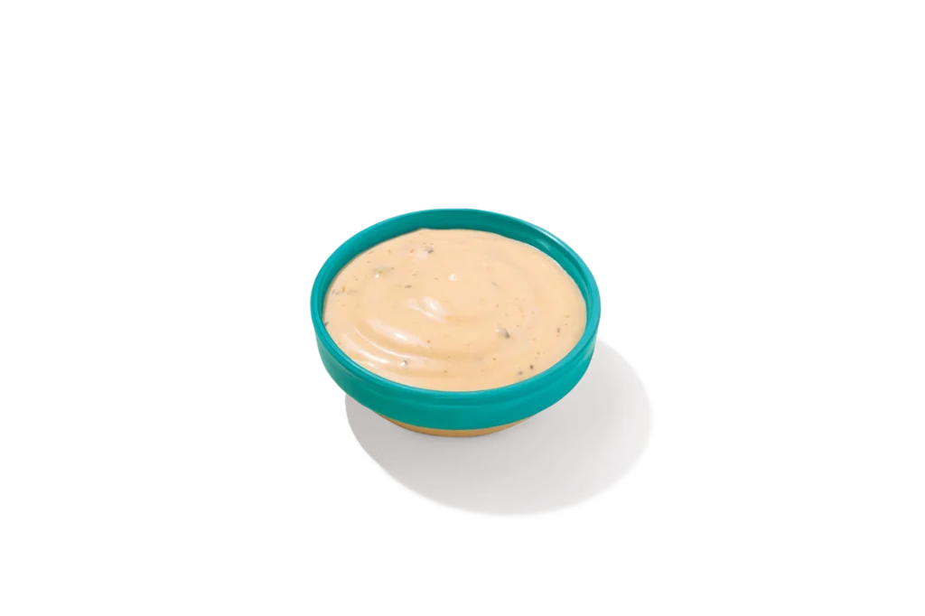 "Bowl of Blackened Ranch Sauce on a white background."