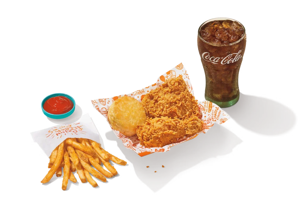 "2Pc Signature Chicken meal with crispy fried chicken, fries, biscuit, dipping sauce, and Coca-Cola."
