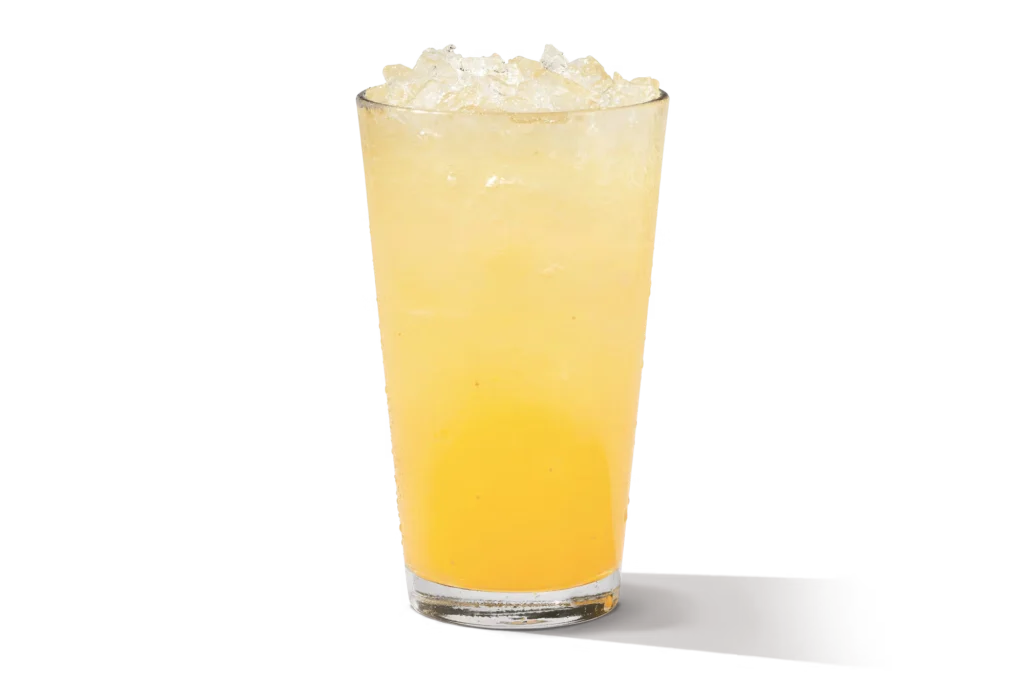 "Glass of chilled pineapple lemonade with ice."