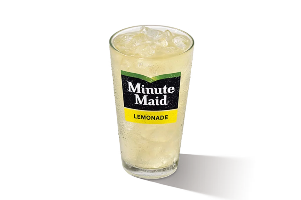 "Glass of Minute Maid Lemonade with ice cubes, Minute Maid logo on the glass, on a white background."