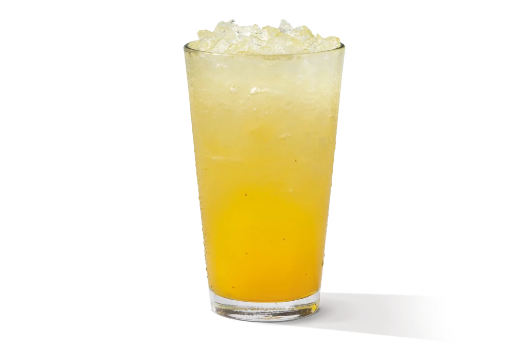 "Glass of mango lemonade with ice."